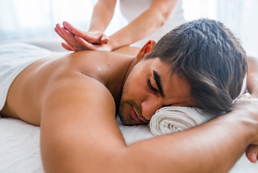 Man getting a deep tissue massage on a massage table