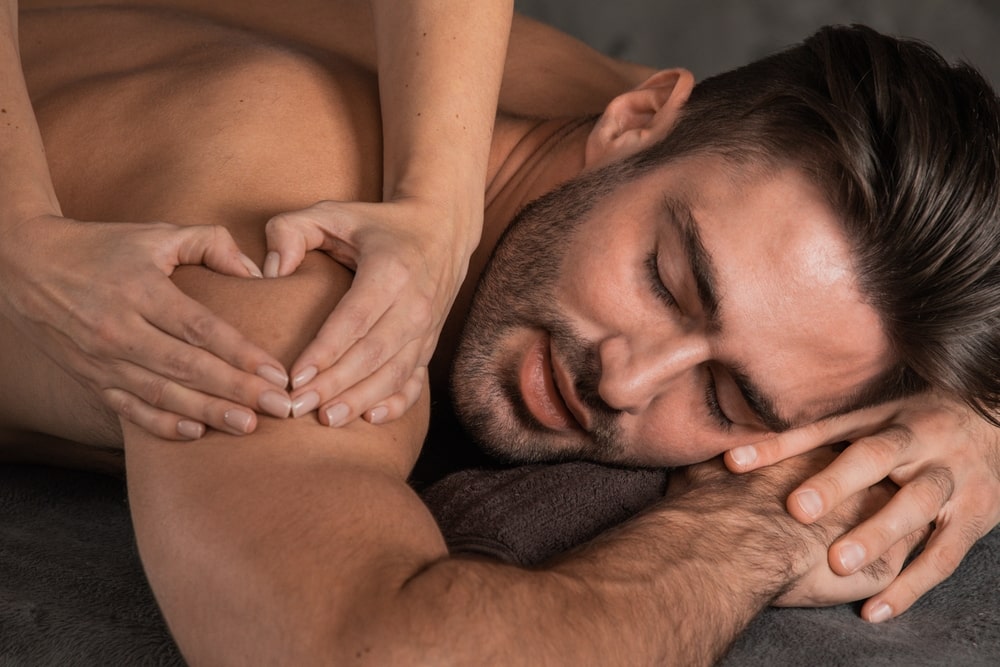 Man lying on a table receiving a massage